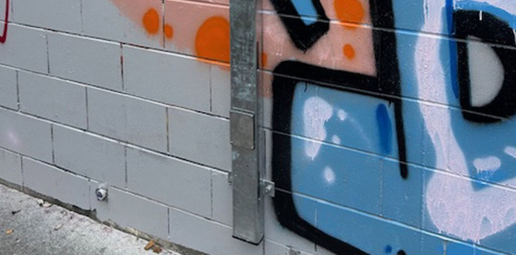 Flood alert sensor installed on an exterior wall to monitor rising water levels